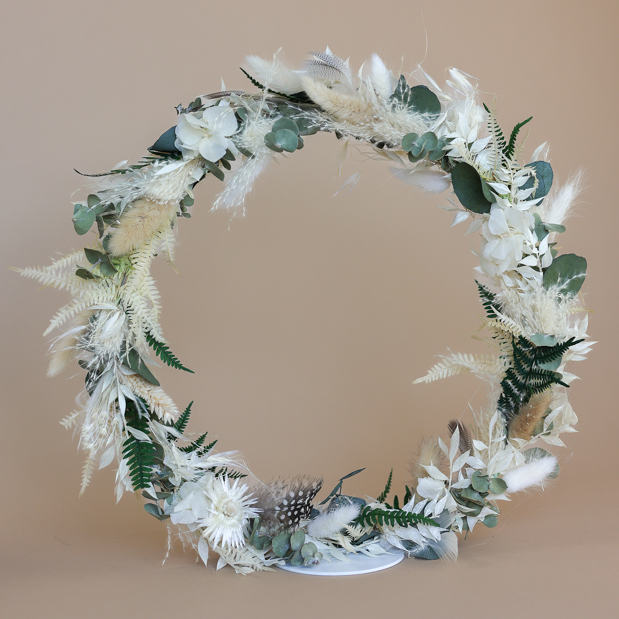 Handgefertigter Tischkranz mit Trockenmaterialien wie Lagurus, Hortensie, Eukalyptus, Capblume, Phalaris und Federn.